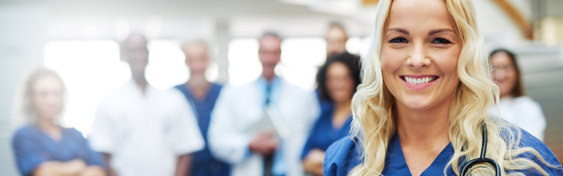 Cheerful woman in hospital looking at camera